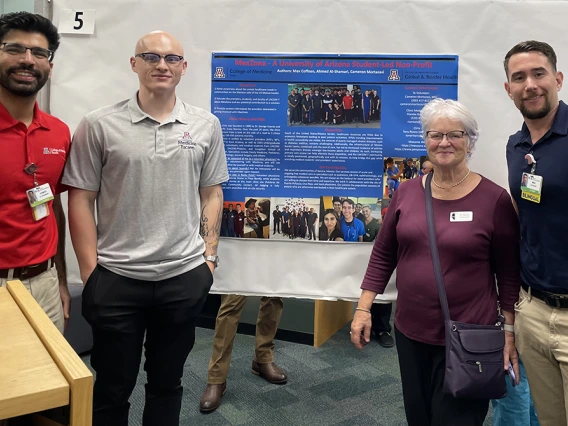 authors in front of poster