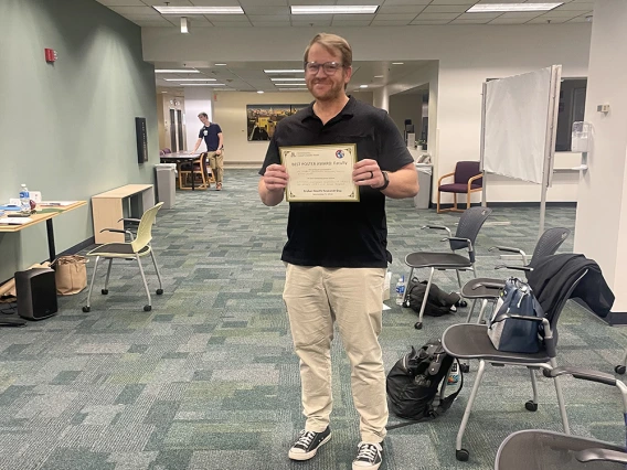 author with award certificate