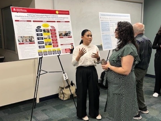 Doctor explaining her project poster
