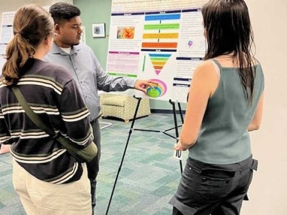 Doctor explaining his project poster