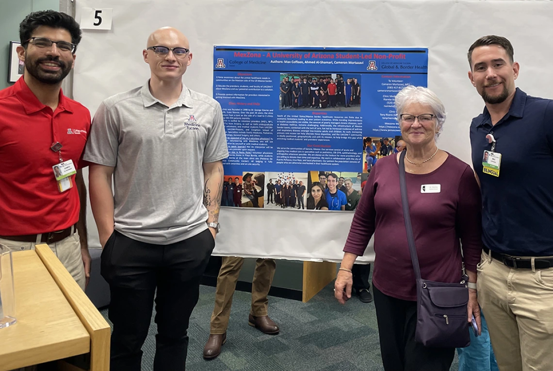 authors in front of poster