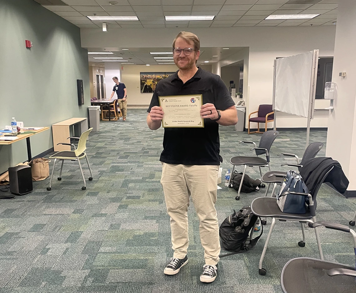 author with award certificate